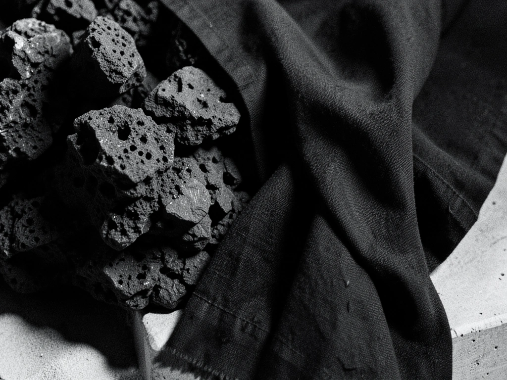 Textured charcoal and volcanic rock landscape